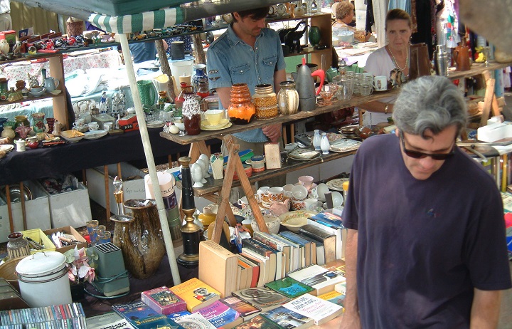 Shoppers at a stall at Rozelle collectors markets, a weekly weekend market in Sydney